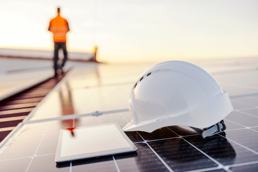 Worker on solar panel with hard hat
